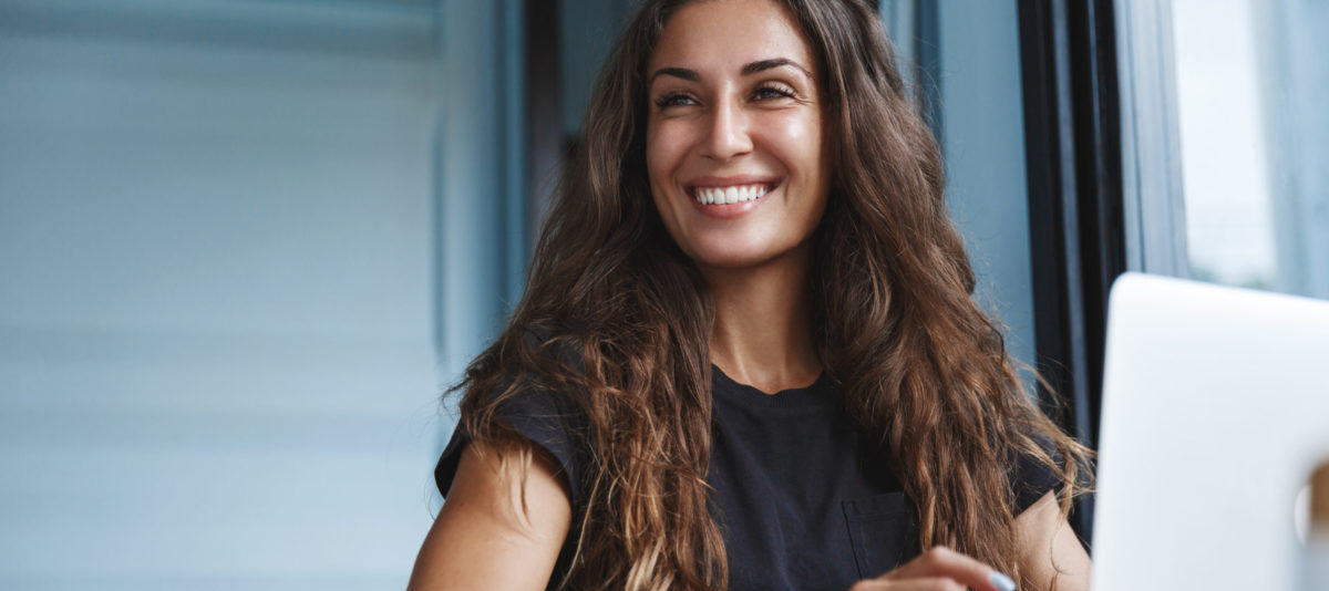 Woman smiling working on computer